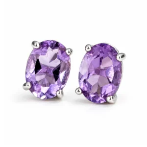 Pair of oval Amethyst stud earrings set in polished 925 sterling silver on a white background.