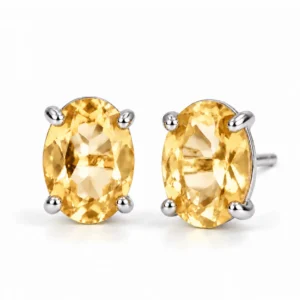 Pair of oval Citrine stud earrings set in polished 925 sterling silver with faceted golden yellow gemstones on a white background.